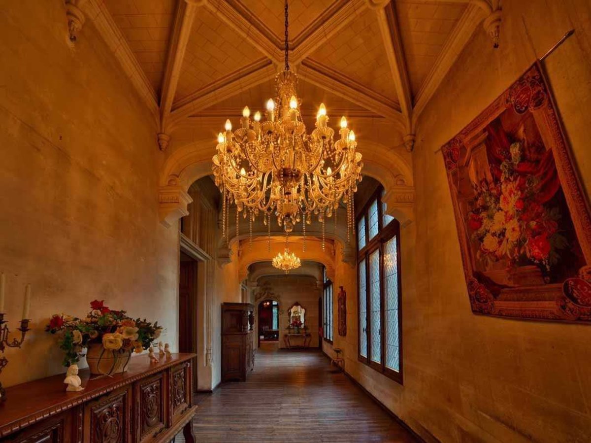the-original-stonework-paired-with-exquisite-chandeliers-and-rich-tapestries-combine-to-create-a-hallway-that-is-a-treat-to-walk-through